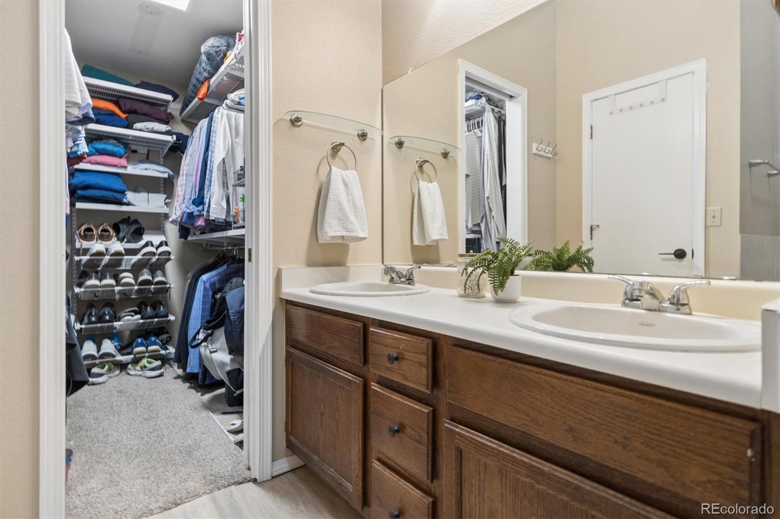 7191 Palisade Drive Highlands Ranch, CO 80130 - Photo 26 of 39 a bathroom with a double vanity sink and a mirror
