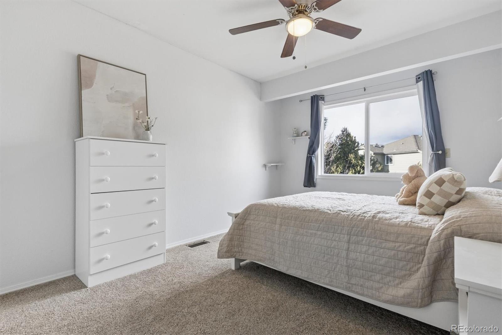 7191 Palisade Drive Highlands Ranch, CO 80130 - Photo 27 of 39 a bedroom with a bed and a window
