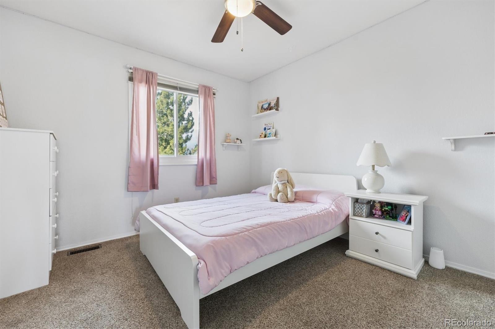 7191 Palisade Drive Highlands Ranch, CO 80130 - Photo 28 of 39 a bedroom with a bed and a window
