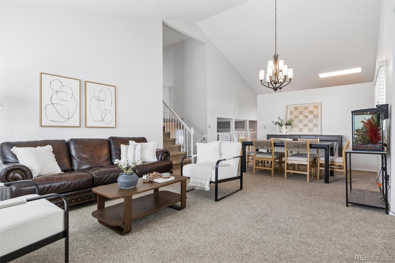 7191 Palisade Drive Highlands Ranch, CO 80130 - Photo 5 of 39 a living room with furniture chandelier and kitchen view
