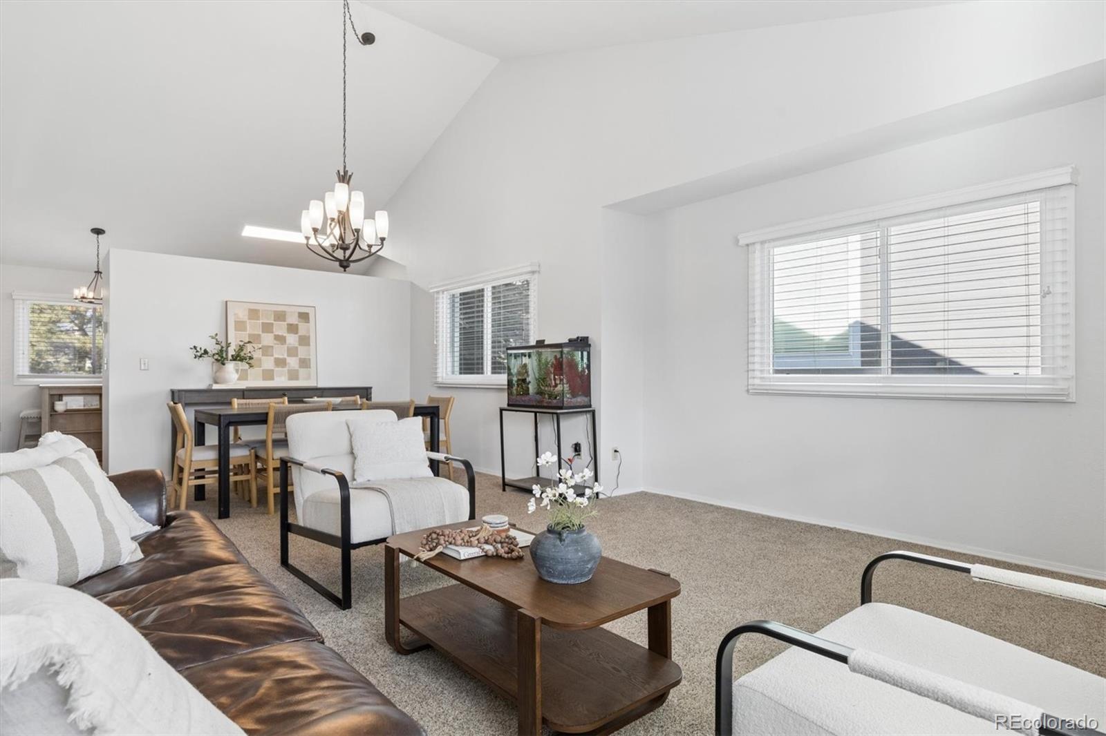 7191 Palisade Drive Highlands Ranch, CO 80130 - Photo 6 of 39 a living room with furniture chandelier and window