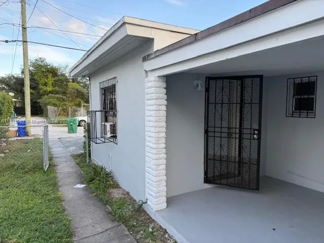 a view of a porch with furniture and floor to ceiling window