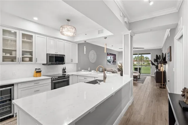 a large white kitchen with stainless steel appliances
