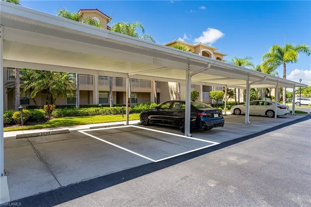 a view of a cars park in front of a building