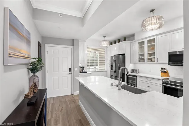 a kitchen with a sink stainless steel appliances and cabinets
