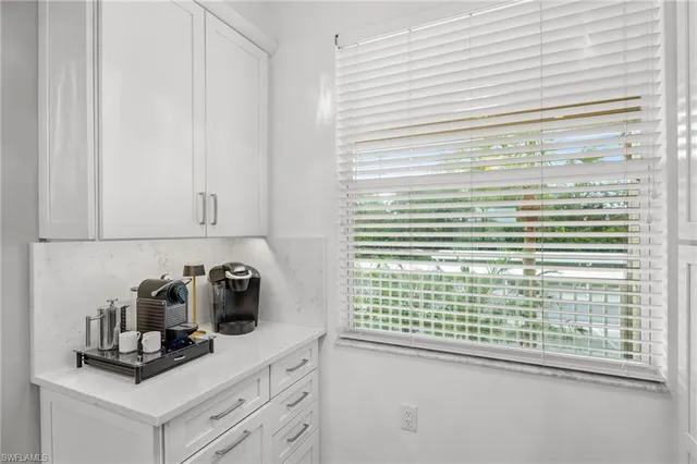 a kitchen with cabinets and window