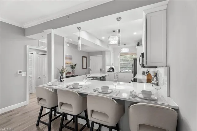 a living room with furniture a chandelier and a table