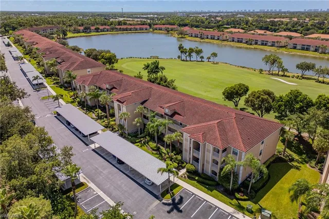 an aerial view of a house with a garden and lake view