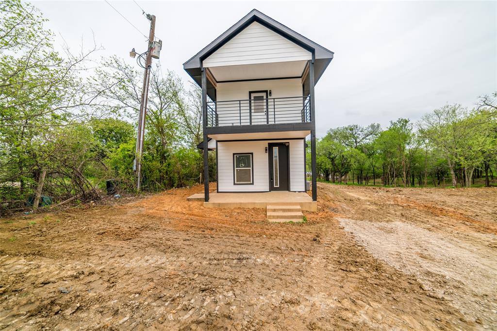 956 Lloyd's Road Little Elm, TX 75068 - Photo 1 of 1 a front view of a house with a yard and trees