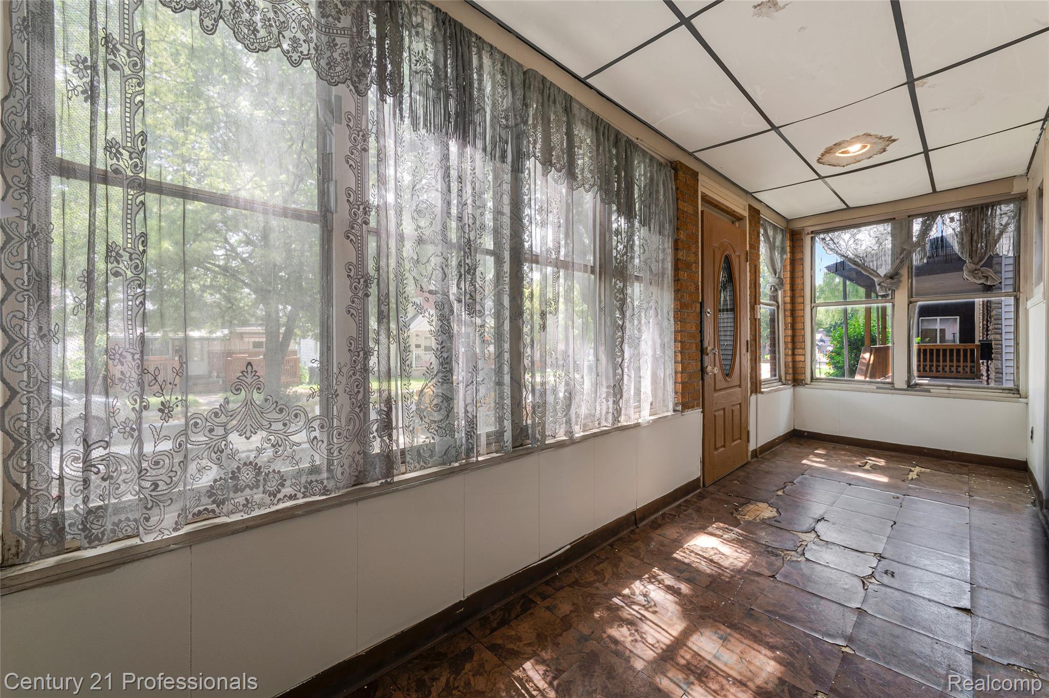238 Richter Street River Rouge, MI 48218 - Photo 5 of 33 Enclosed porch with multiple windows, a paneled ceiling, and a wood-panel door
