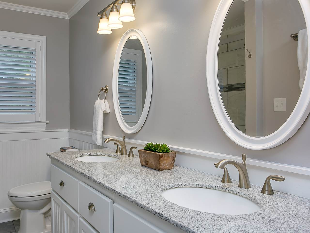 2004 Countrywood Road North Raleigh, NC 27615 - Photo 15 of 25 Updated bath with tile floor, dual sinks with granite countertop, and beadboard. Hall Bathroom