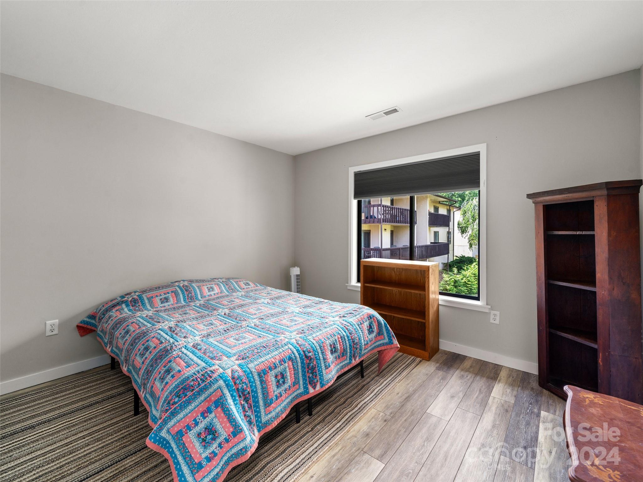 111 Shepard Square, Unit 608 Brevard, NC 28712 - Photo 11 of 29 a bedroom with a bed and a window