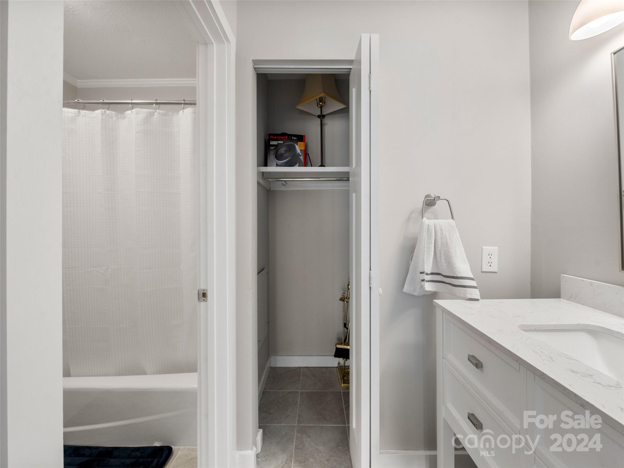 111 Shepard Square, Unit 608 Brevard, NC 28712 - Photo 17 of 29 a bathroom with a granite countertop sink mirror and vanity