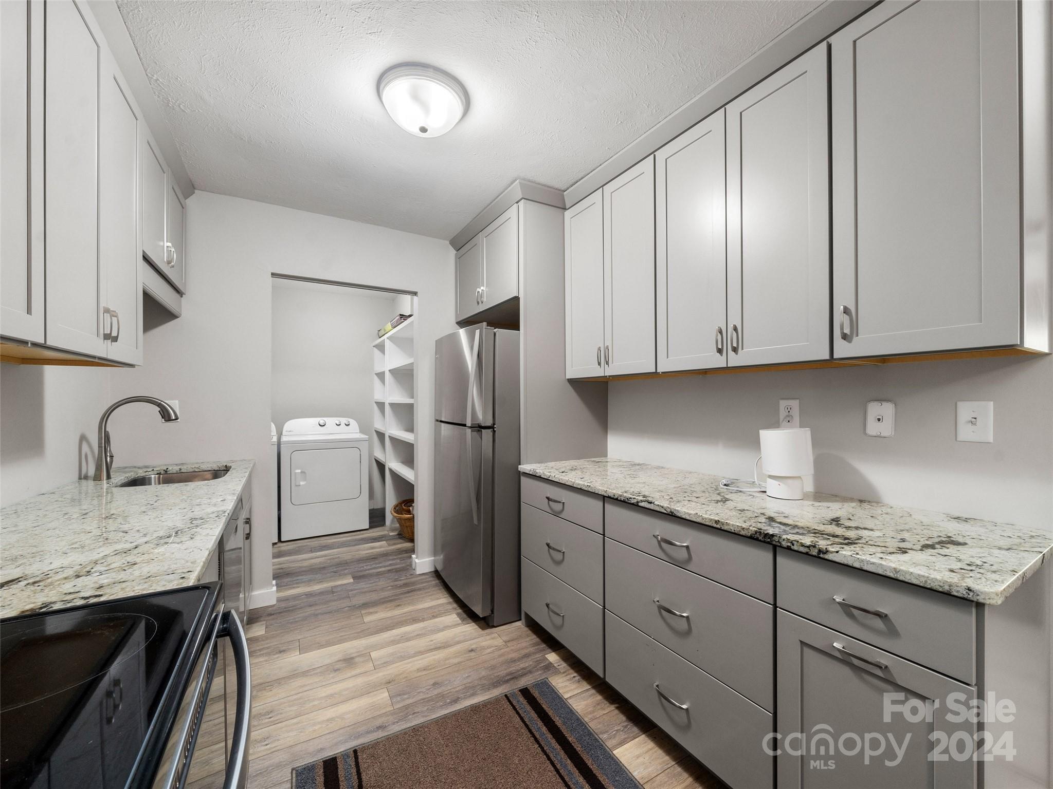 111 Shepard Square, Unit 608 Brevard, NC 28712 - Photo 8 of 29 a kitchen with a sink a refrigerator and cabinets