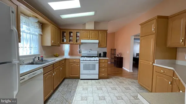 a kitchen with a sink stove and refrigerator