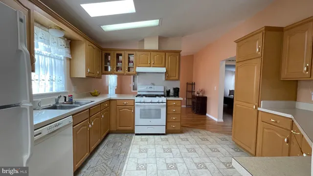 a kitchen with a sink stove and refrigerator