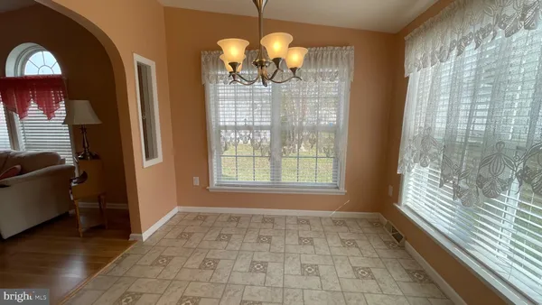 a room with window and chandelier