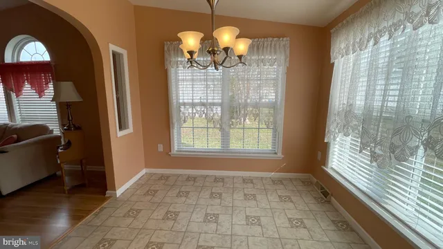 a room with window and chandelier
