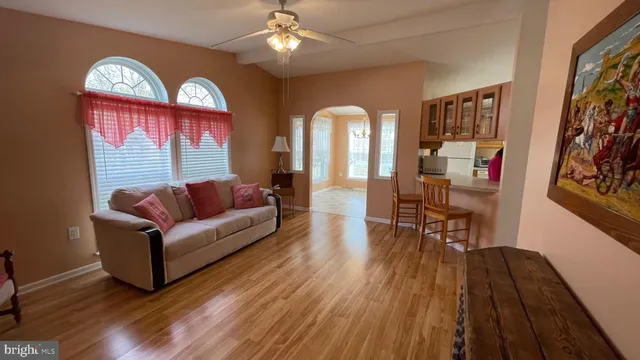 a living room with furniture and a wooden floor
