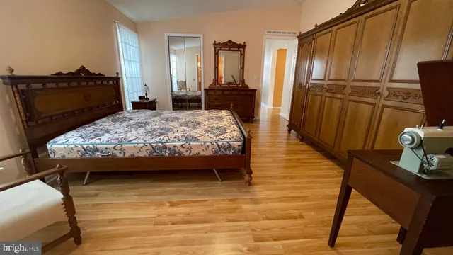a bedroom with furniture and wooden floor