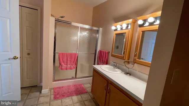 a bathroom with a sink vanity and a mirror