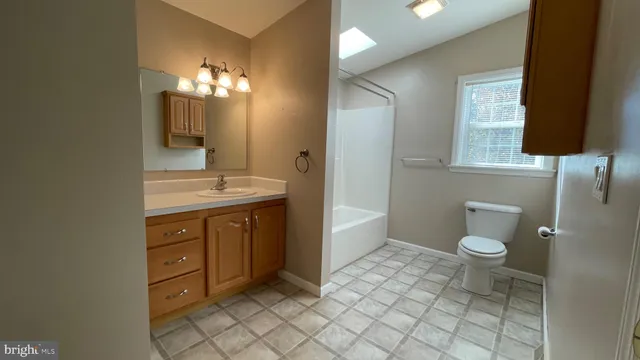 a view of a room with wooden floor and large windows