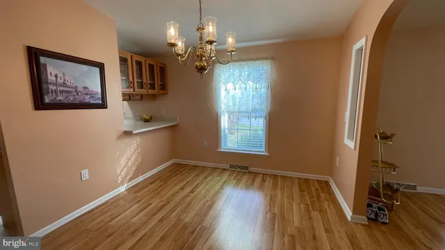 a view of a livingroom with furniture wooden floor and windows