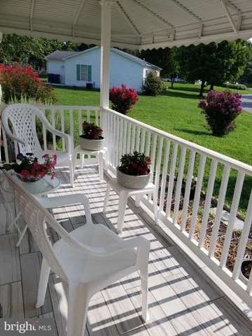 a view of a two chairs and table in the patio
