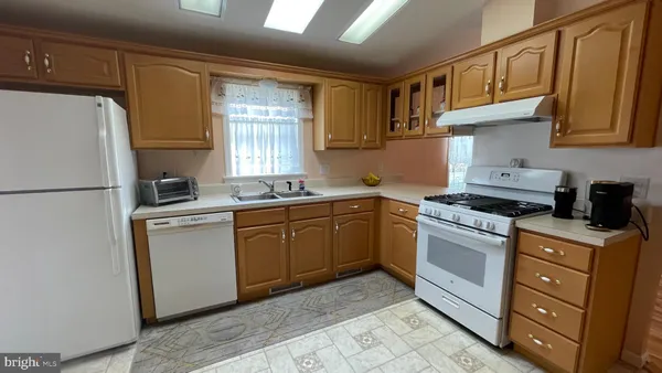 a kitchen with stainless steel appliances granite countertop a refrigerator sink and cabinets