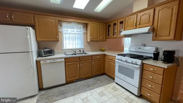 a kitchen with stainless steel appliances granite countertop a refrigerator sink and cabinets