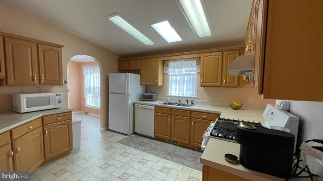 a kitchen with a stove a sink and a refrigerator