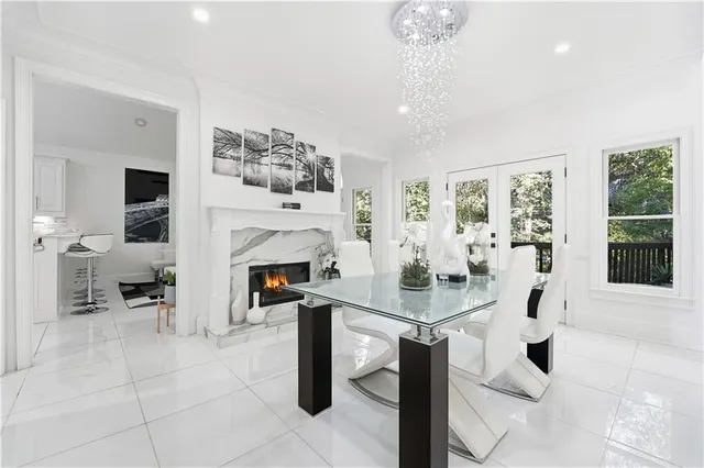 a living room with furniture a chandelier and a flat screen tv