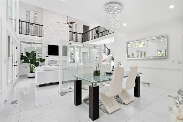 a living room with furniture a chandelier and a floor to ceiling window