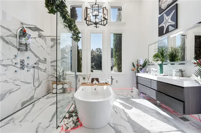 a bathroom with a tub sink and mirror