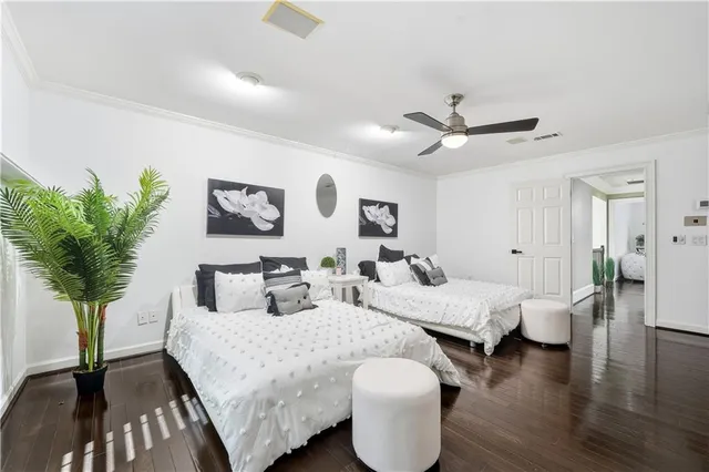 a bedroom with a bed and a painting on the wall