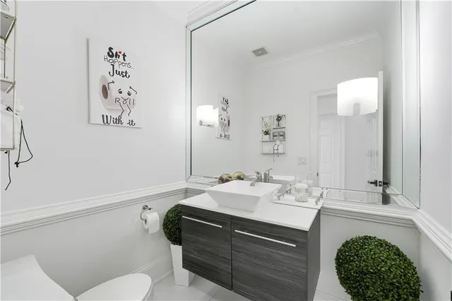 a bathroom with a shower sink vanity mirror and toilet