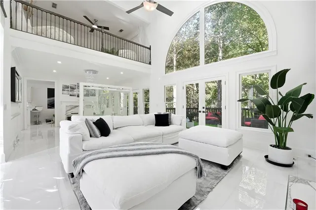 a living room with furniture a flat screen tv and a fireplace