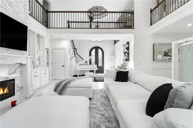 a living room with furniture a fireplace and a flat screen tv