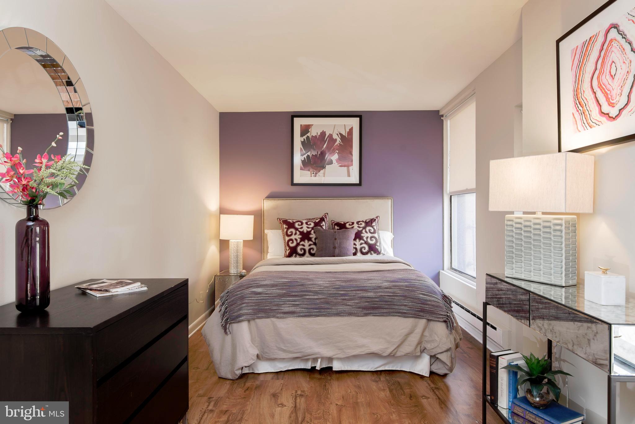 201 South 13th Street, Unit 1112 Philadelphia, PA 19107 - Photo 2 of 23 a bedroom with a bed and a potted plant