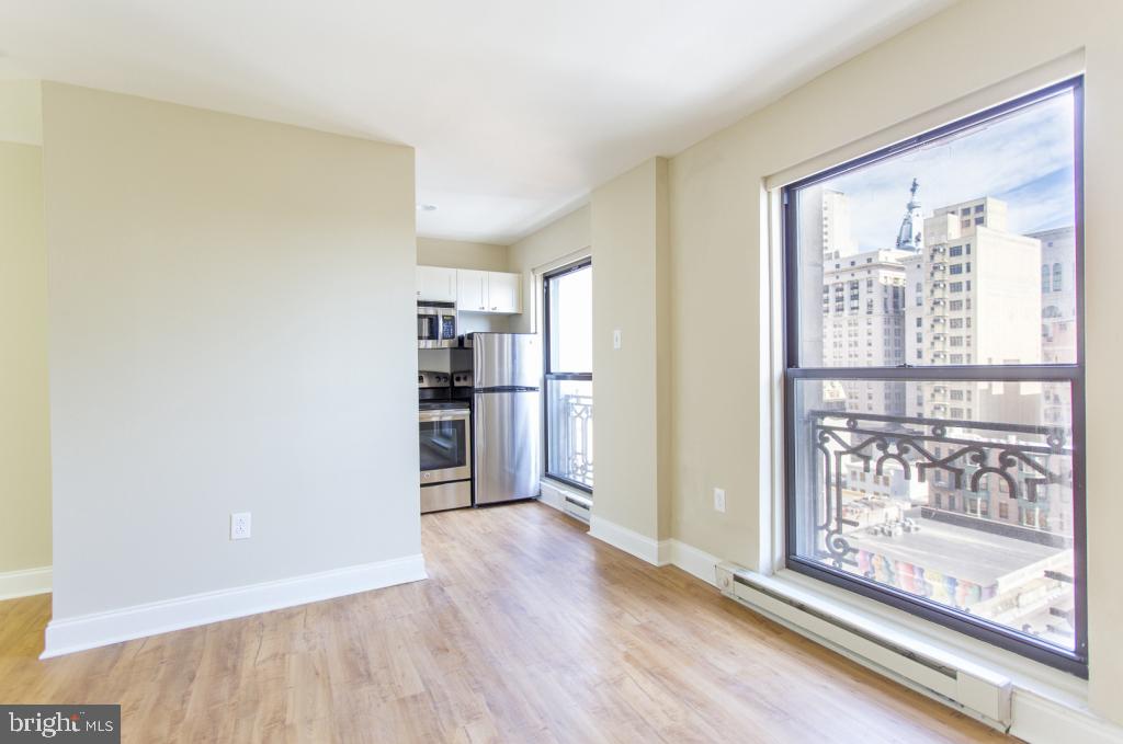 201 South 13th Street, Unit 1112 Philadelphia, PA 19107 - Photo 9 of 23 a view of a kitchen with wooden floor and entrance