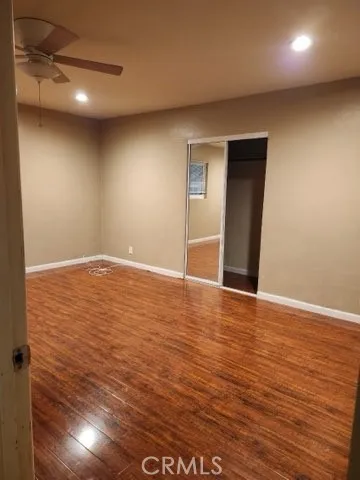 a view of a street with a wooden fence