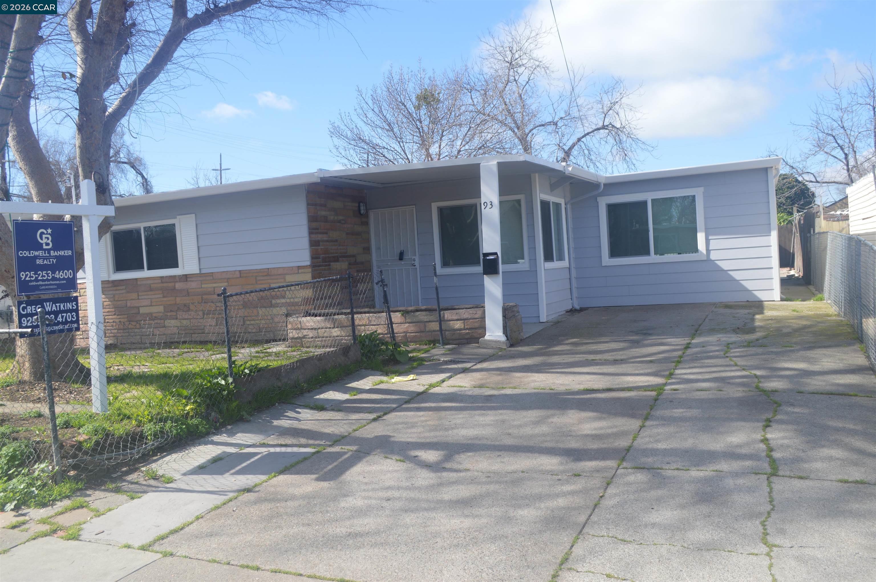a front view of a house with a yard and a garage