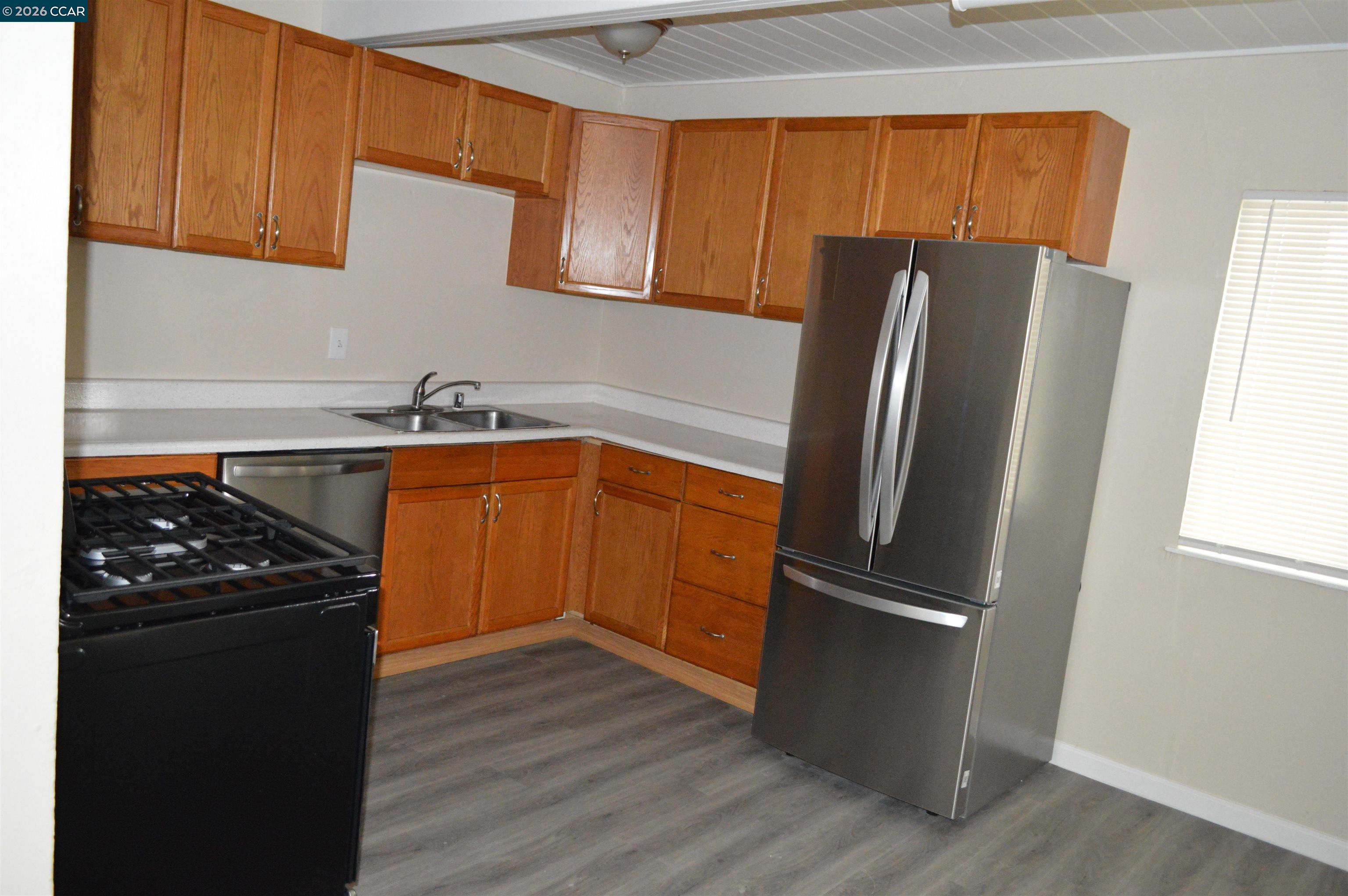 93 Beach Drive Bay Point, CA 94565 - Photo 3 of 9 a kitchen with stainless steel appliances granite countertop a refrigerator and a sink