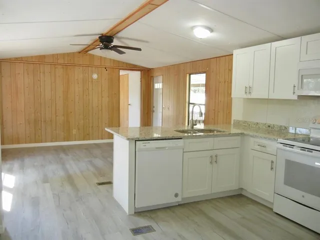 a kitchen with sink cabinets and wooden floor