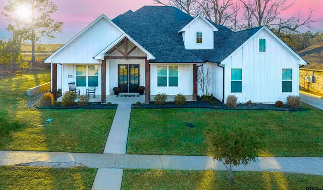 a front view of a house with a yard table and chairs
