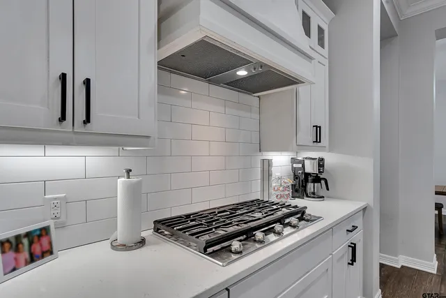 a stove top oven sitting inside of a kitchen