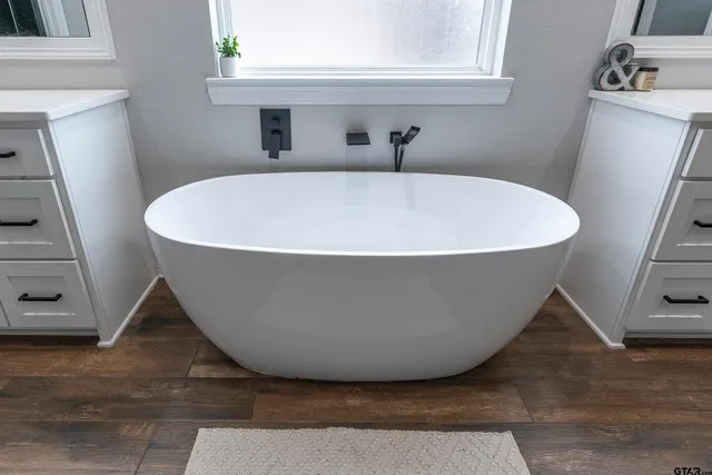 a white bath tub sitting in a bathroom
