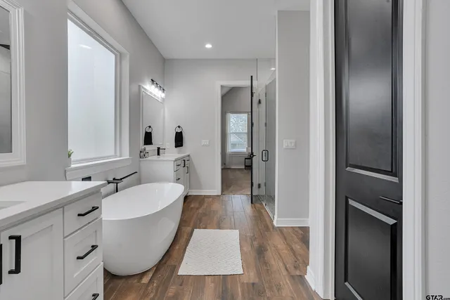 a spacious bathroom with a sink mirror and shower