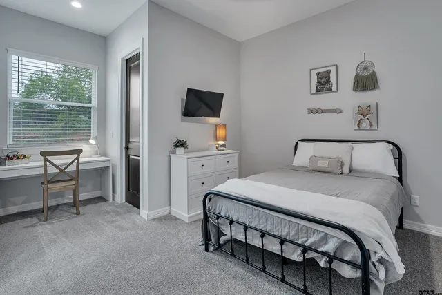 a bedroom with a bed chair and window