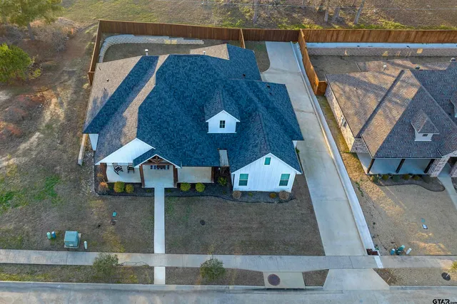 a front view of a house with plants